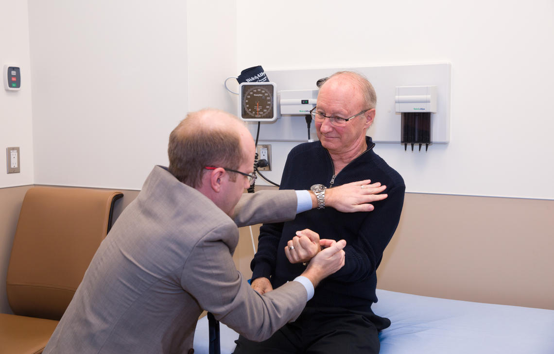 Dr. Lawrence Korngut, assistant neurology professor and clinical neurophysiologist, examines his patient Cliff Barr as part of a clinical trial using an antipsychotic drug to treat Amyotrophic Lateral Sclerosis (ALS). Photos by Riley Brandt, University of Calgary 
