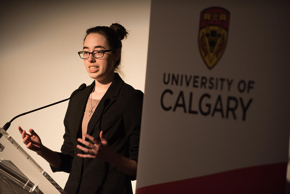 First-year student Megan Koevoet gives closing remarks at the Global Challenges dinner on March 28, an experiential learning opportunity for the class.