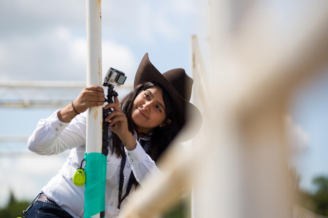 Second-year vet med student Zeanna Janmohamed adjusts a camera set up to monitor the bulls.