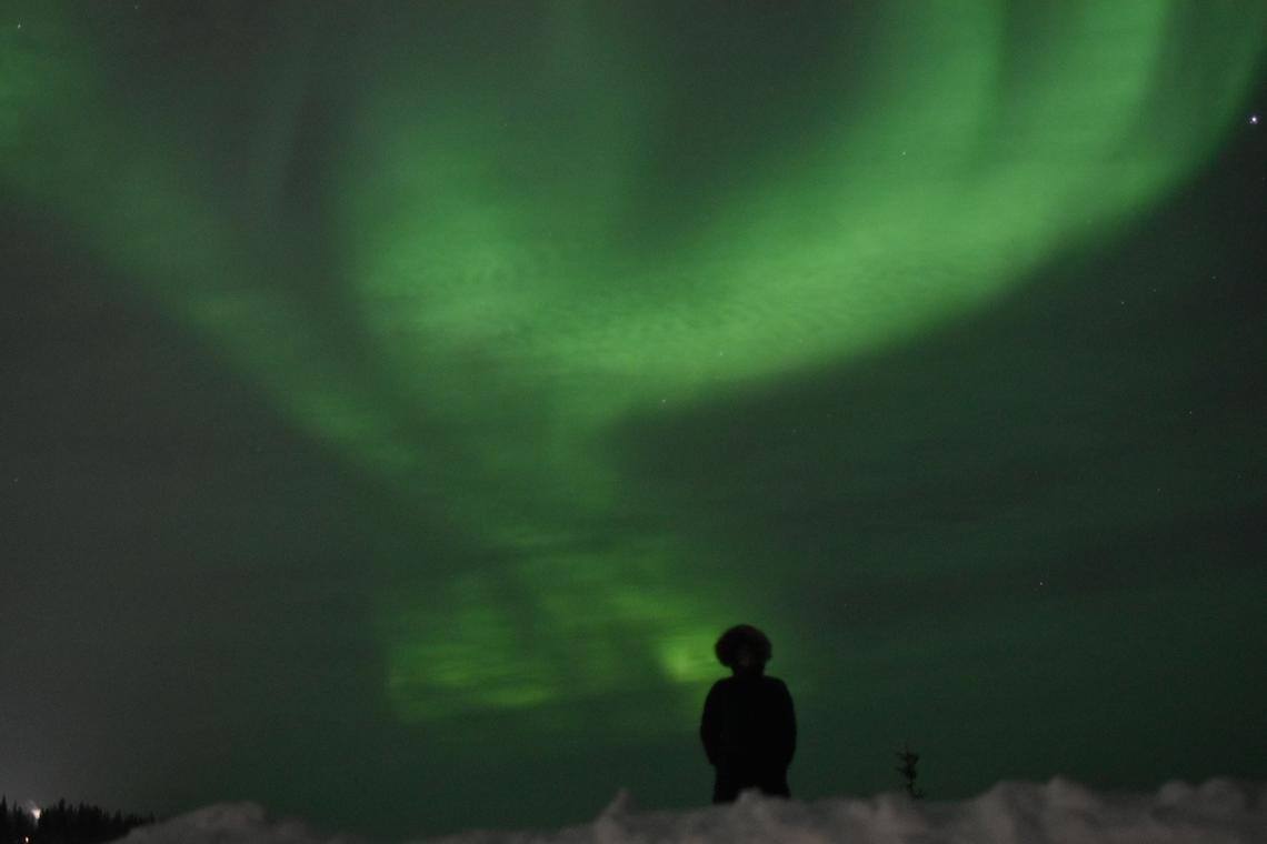 Chesley Zurowski watches the mesmerizing display of aurora borealis in Tulita. 
