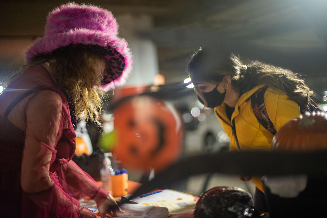 Student staff members help with Trick or Eat