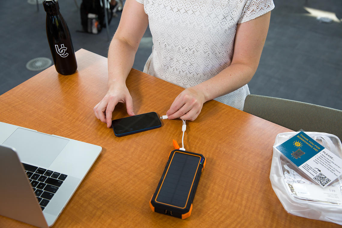 UCalgary student with solar phone charger