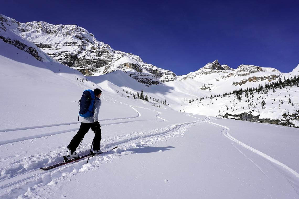 Person skiing in backcountry with a backpack on