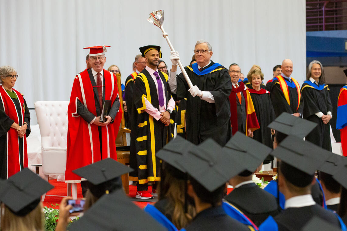 Dr. Bob with the UCalgary mace at the June 2023 Convocation.