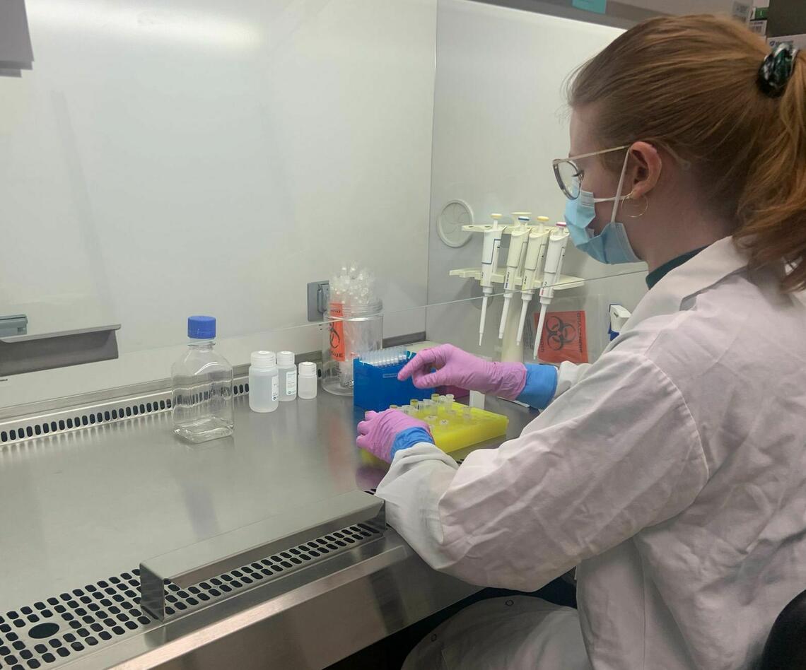 Jess Churcher uses a pipette in a research lab
