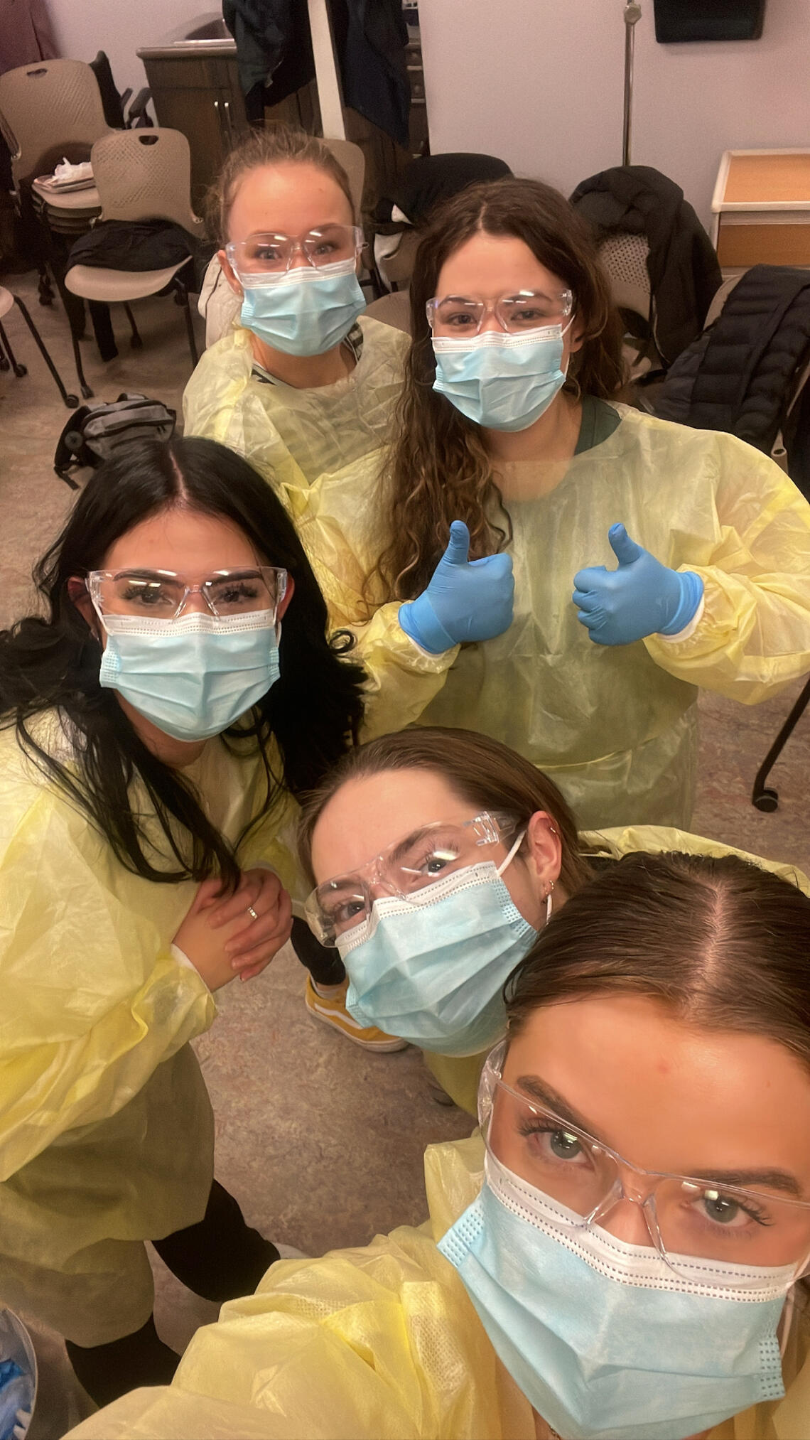 Kristi-Anne poses with fellow nursing students in wearing PPE