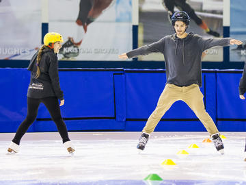 Students try ice skating at the Olympic Oval