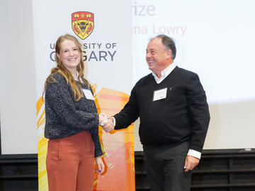 Dana Lowry (Kinesiology), left, receives the Byers Prize from Killam Trustee Bernard Miller, right