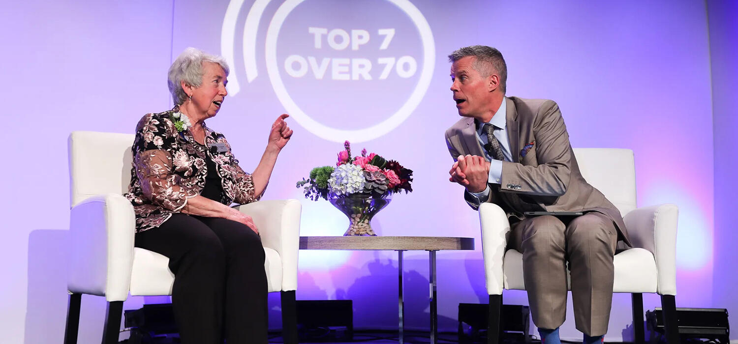 Bonnie Kaplan and Dave Kelly on stage at the Top7 over 70 Awards Gala in May 2022