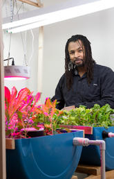 Tatenda Mambo, postdoctoral associate, Sustainability Studies, displays his aquaponics research. Photo by Riley Brandt, University of Calgary