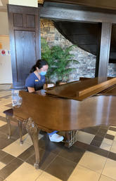 Wang playing piano at Tudor Manor for residents