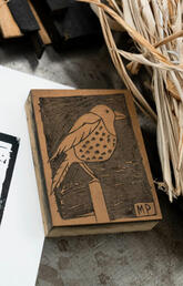 A bird lino block and kozo fibre from the mulberry tree.