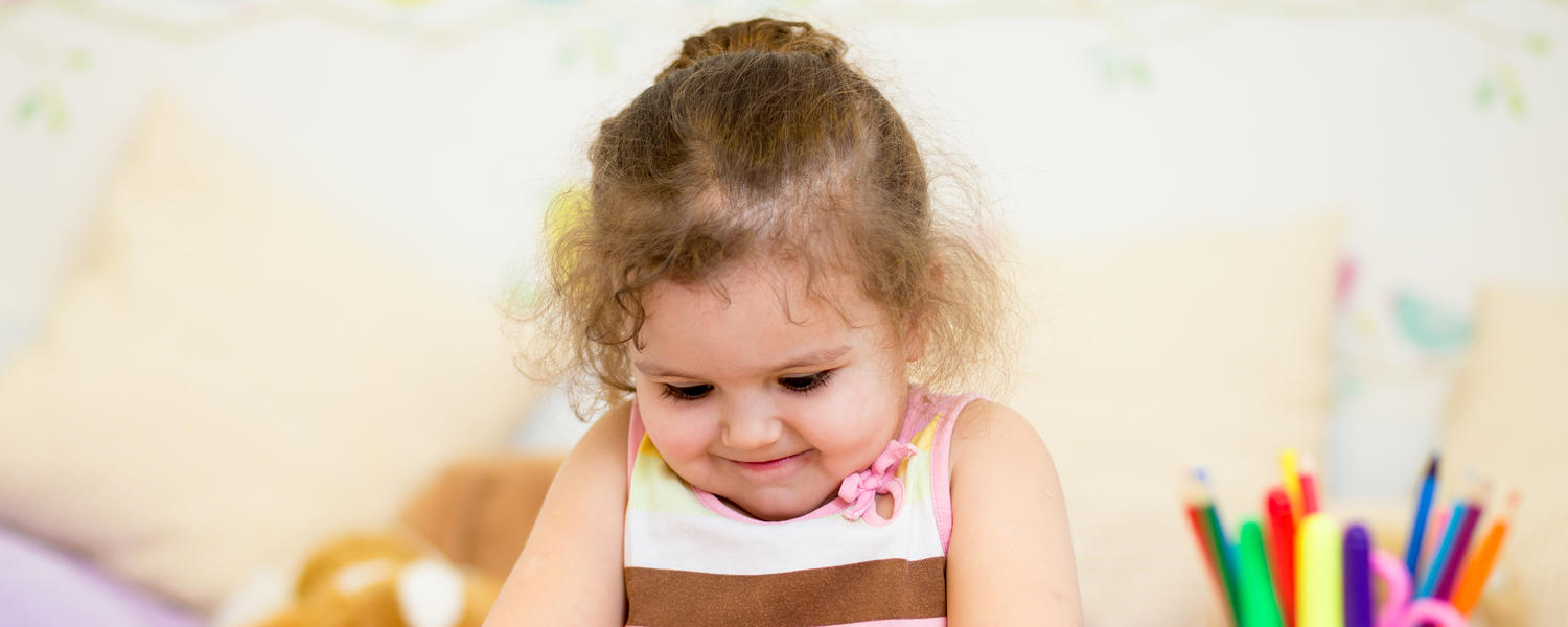 girl rolling play dough