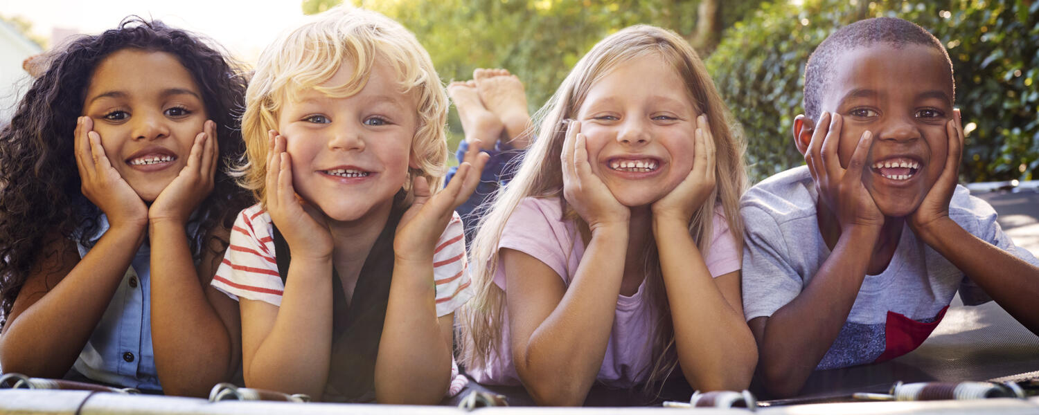 kids laying on trampoline