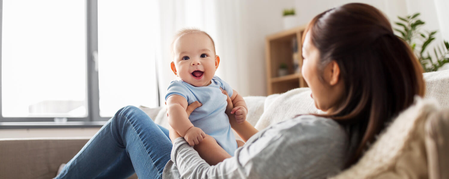 baby boy with mom on couch