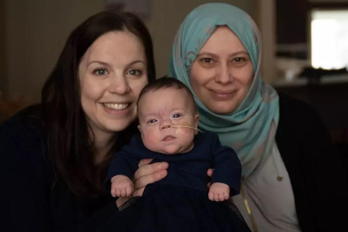 Holly, centre, is one of the babies in the study, seen here with her mom, at left, and researcher Jumana Samara.