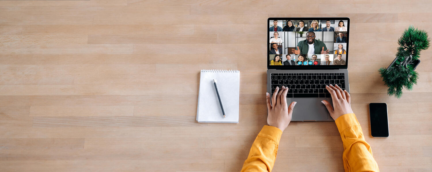 person participating in a group call on laptop 