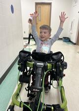 photo of boy using robotic walking device 