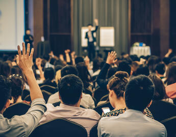 group of crowd listening to a speaker
